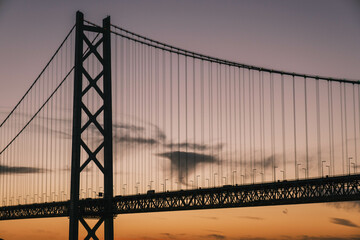 [HYOGO]Sunset view of Akashi Kaikyo Bridge, known as one of the world's largest suspension bridges, The faint orange sunset sky is beautiful, Azur Maiko, Japan