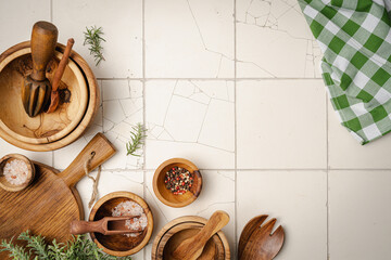 Old wooden kitchen utensils or cooking tools and bowls on white tile background, top view, flat...