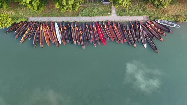 Aerial footage of traditional punt boats (Stocherkahn) on the Neckar River in T&uuml;bingen