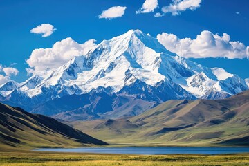Snow-Capped Mountain Peak with a Serene Lake and Rolling Green Hills