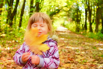 happy child playing outdoors in autumn in the park