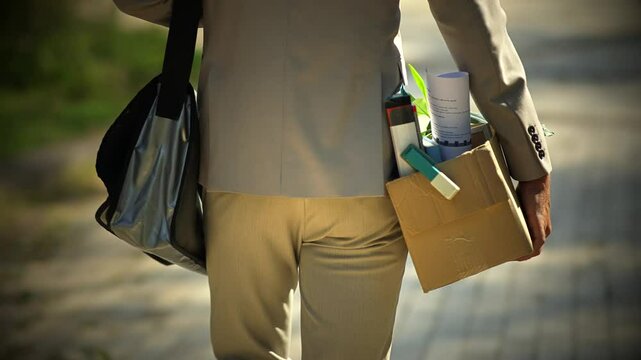 Fired office worker sadly leaving work 