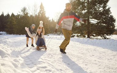 Winter family fun, snowy outdoor activity, sledging holiday wearing warm outfit, happy children, excited father sliding downhill over snow mother on sledge, enjoy weekend activity walking in forest