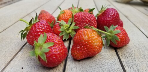 Freshly Picked Strawberries on Rustic Wooden Surface - Vibrant and Juicy
