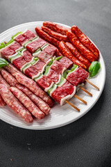 raw sausage meat assorted juicy pork, beef fresh delicious gourmet food background on the table rustick food top view copy space