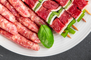 raw sausage meat assorted juicy pork, beef fresh delicious gourmet food background on the table...