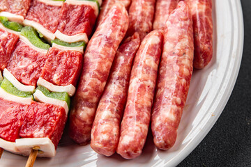 raw sausage meat assorted juicy pork, beef fresh delicious gourmet food background on the table rustick food top view copy space