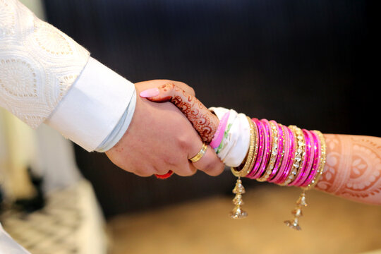 Traditional indian wedding ceremony, groom holding hand in bride hand. Timeless moment of togetherness, symbolizing love and commitment.