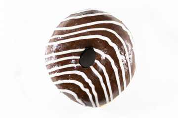 Delicious chocolate donut drizzled with white chocolate stripes, set against a clean white background. Perfect for sweet treat promotions or dessert-related content.