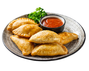 Portion of colombian fried empanadas with red sauce on plate isolated on white background