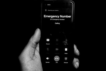 Hand of a Person Making an Emergency Call on a Mobile Phone – Urgent Communication Concept
