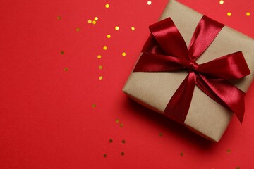 Beautiful gift box with confetti on a colored background