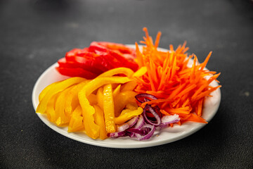 salad mix vegetables cut into a plate tomato, carrot, pepper, onion juicy fresh gourmet food background on the table rustic food top view copy space keto and paleo diet Vegetarian and vegan