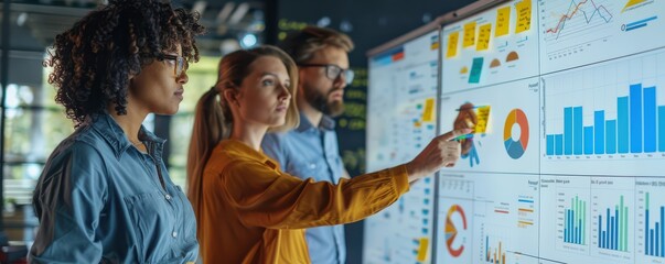 Focused team collaborating on brainstorming session, using sticky notes on a whiteboard.