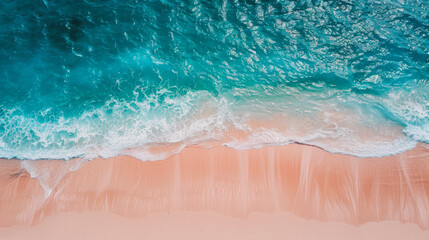 Aerial view of turquoise ocean waves crashing onto a sandy beach under bright daylight