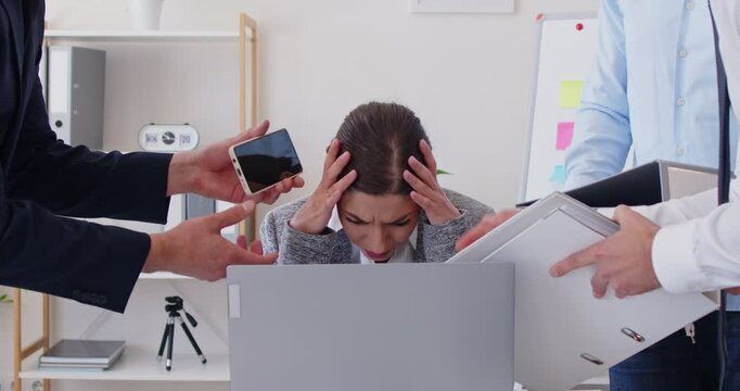 Tired businesswoman experiencing stress and burnout due to a high workload and a large number of tasks with paperwork in the office. Challenges and problems faced by individuals in work environments.