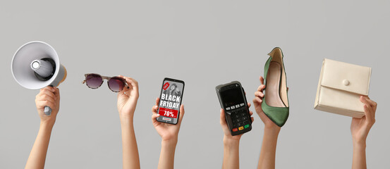 Female hands with mobile phone, women accessories and megaphone on grey background. Black Friday...
