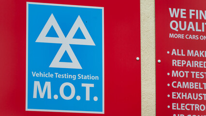 MOT Vehicle Testing Station Sign on a Red Background
