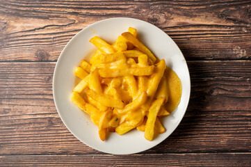 Caption: Tasty Caribbean food served on a white plate or white bowl on a rustic vintage wooden table backdrop - colorful home cooked meals and desserts with chicken, chips, vegetables, rice, bbq, stew