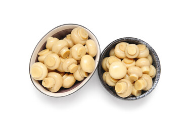 Bowls of canned mushrooms isolated on white background