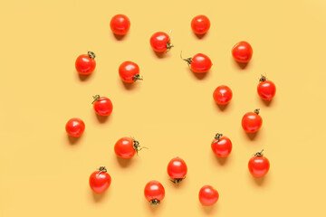 Frame made of fresh cherry tomatoes on yellow background