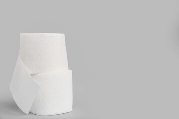 Rolls of toilet paper on grey background