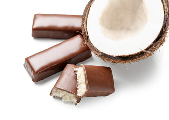 Tasty chocolate covered coconut candies on white background