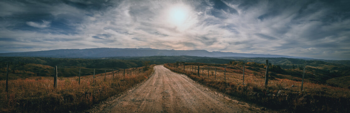 Perspective view of an unpaved road through the landscape of San Miguel de los Rios steppen in Cordoba, Argentina