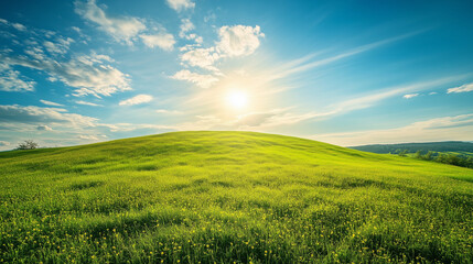 Obraz premium Bright Green Hill Under Blue Sky with Shining Sun