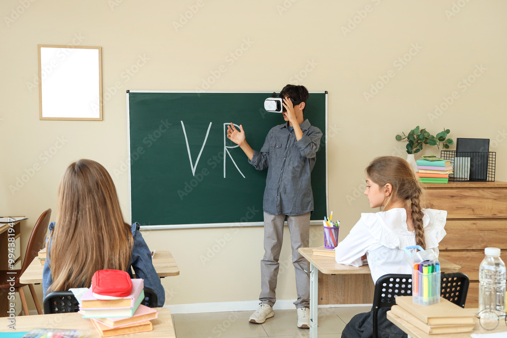 Canvas Prints Teenage boy using VR glasses during lesson in classroom