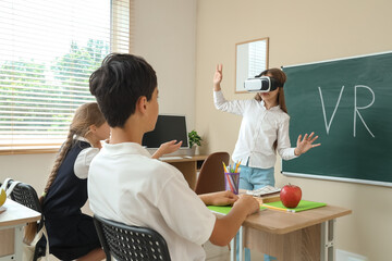 Teenage girl using VR glasses at blackboard in classroom