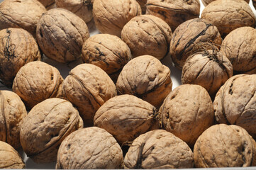 minimal close up whole walnuts on blue background, copy space, frame, top down view