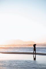 Fototapeta premium surfer watching the sea preparing the next wave at sunset