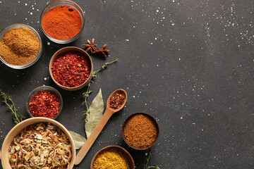 Composition with different aromatic spices on dark background