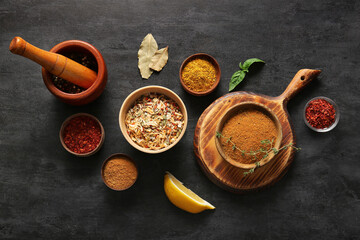 Composition with different aromatic spices on dark background