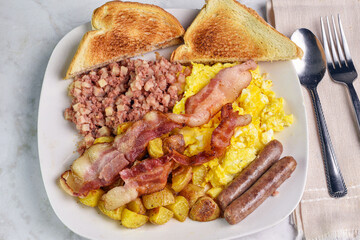 scramble eggs  with home fries and corn beef hash
