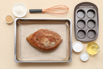 Composition with baking trays, tasty bread and ingredients for pastry on color background