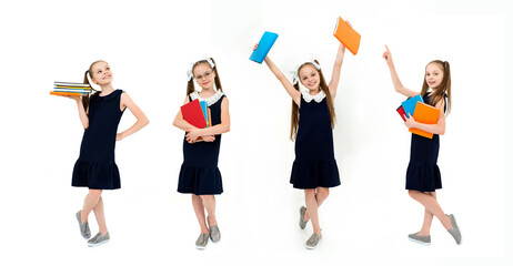 Obraz premium Happy cute child girl in school uniform holding books.
