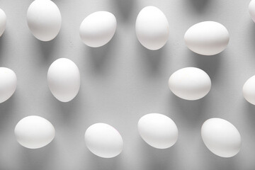 Frame made of raw chicken eggs on grey background