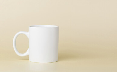 white cup for tea or coffee on a yellow background