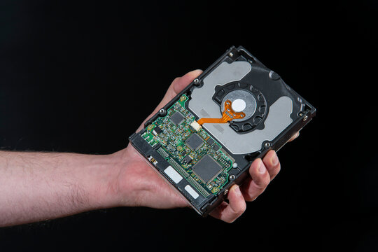 Close up of man's hand holding a computer hard drive