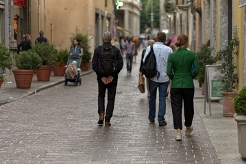 Several tourists in the streets of Como, Italy.