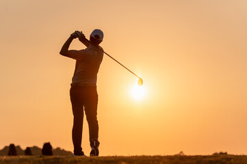 exercise, sunrise, determination, fairway, golf, golf course, golfer, hit, silhouette, tee. A man...