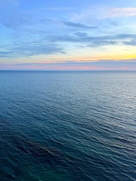 Sunrise sky above sea calm blue water