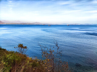 Tranquil seascape with distant ships off the coast on a clear day
