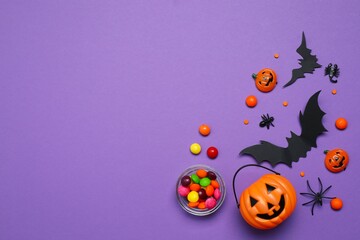 Different Halloween decorations including pumpkins, bats, spiders, confetti on color background