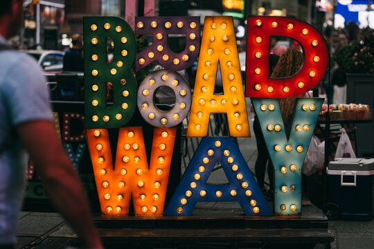Colorful lit Broadway sign in Times Square, New York City street scene