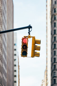 Red light traffic signal in New York City with urban building backdrop