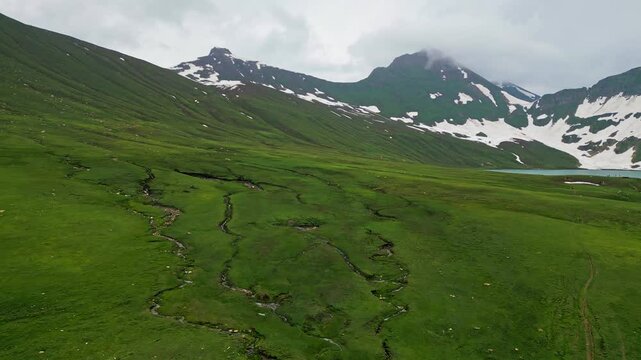 Dudipatsar Lake, a pristine blue alpine lake nestled among the snow-capped mountains of Pakistan's Kaghan Valley.