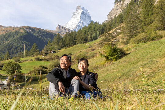 Korean couple enjoying a visit to Zermatt with Matterhorn view